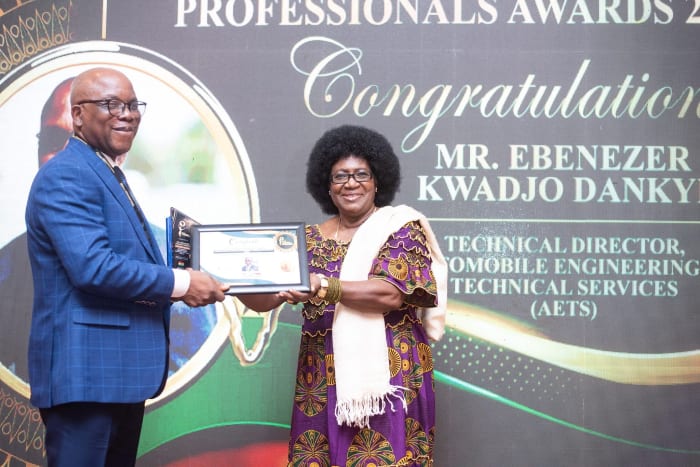 Receiving an award certificate in Tanzania