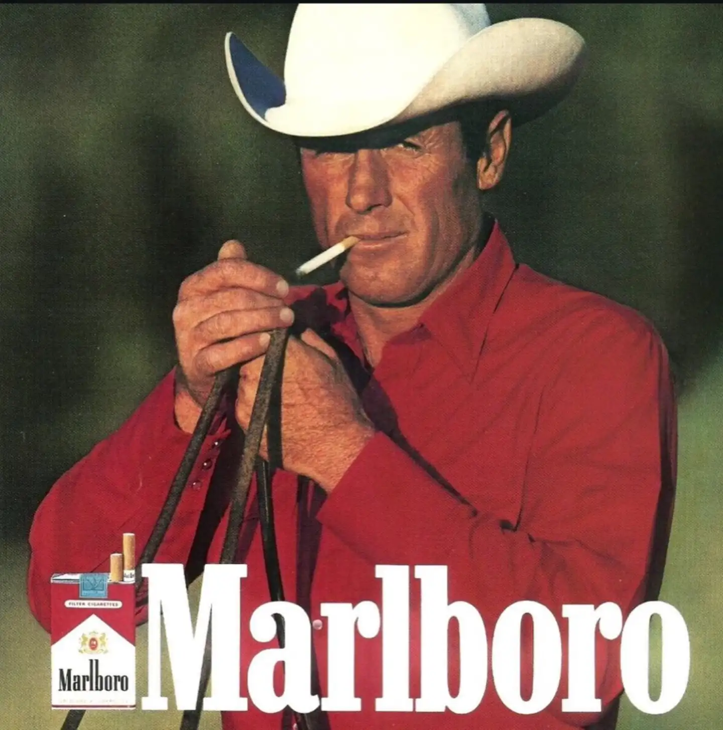 Iconic Marlboro Man cowboy advertisement featuring rugged cowboy in red shirt and white hat lighting a cigarette, symbolizing masculinity and classic cigarette marketing.