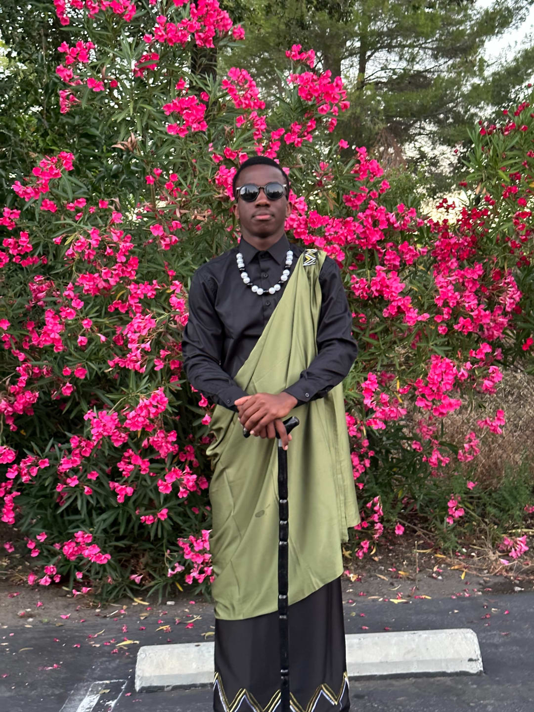 Close up full body photo of Dan Bellamy Biramahire, smiling and looking friendly.