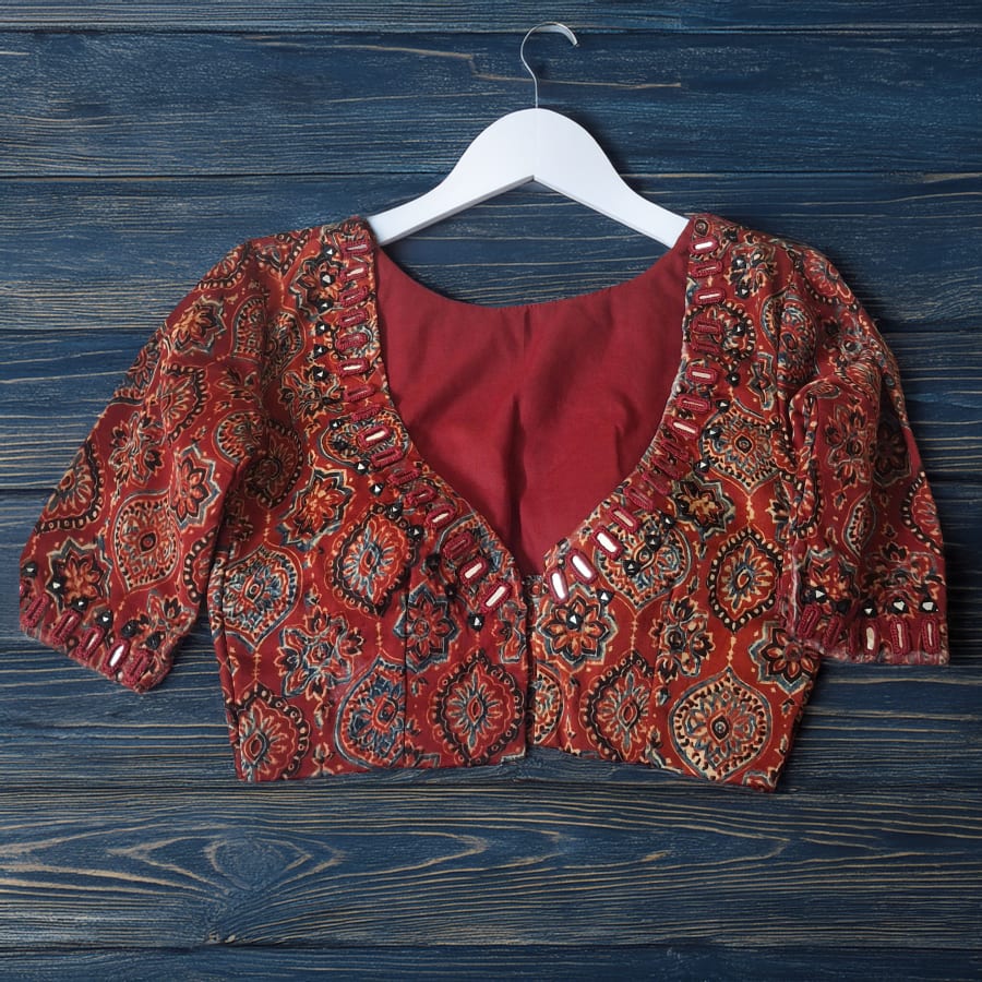 Maroon designer blouse showing precise fitting work by Anagha Creation