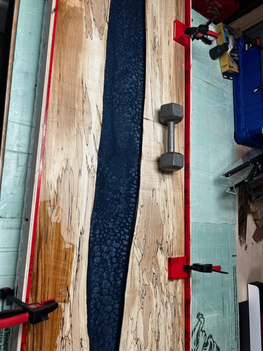 Wood tabletop with epoxy resin.