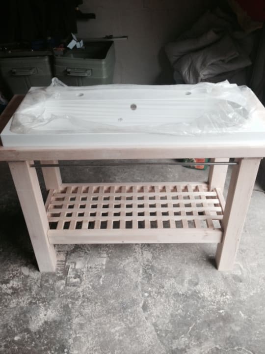 A wooden bathroom vanity with a sink.