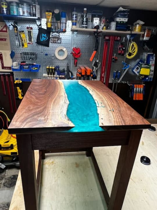 Side view of table with aqua epoxy resin inlay.