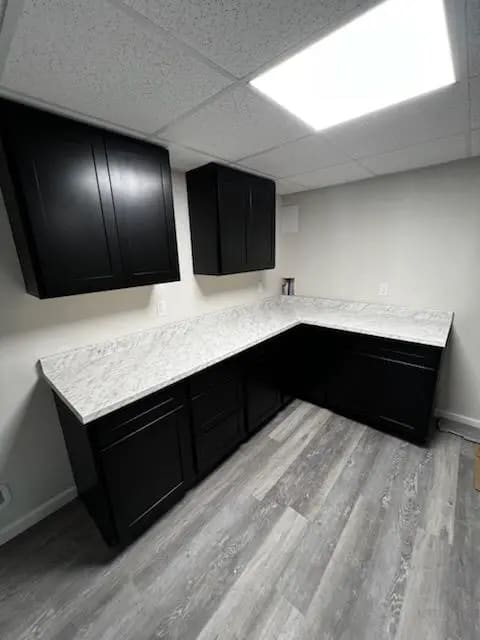 Photo of black kitchenette with shaker-style doors.