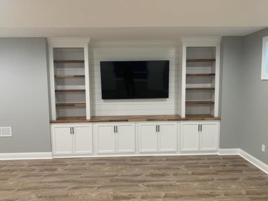 Installation of built-in entertainment center, painted white.