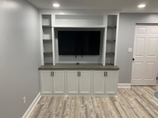 Installed entertainment center, painted white.