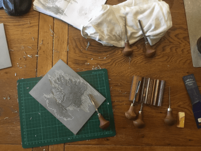 Linocut block in the process of being carved