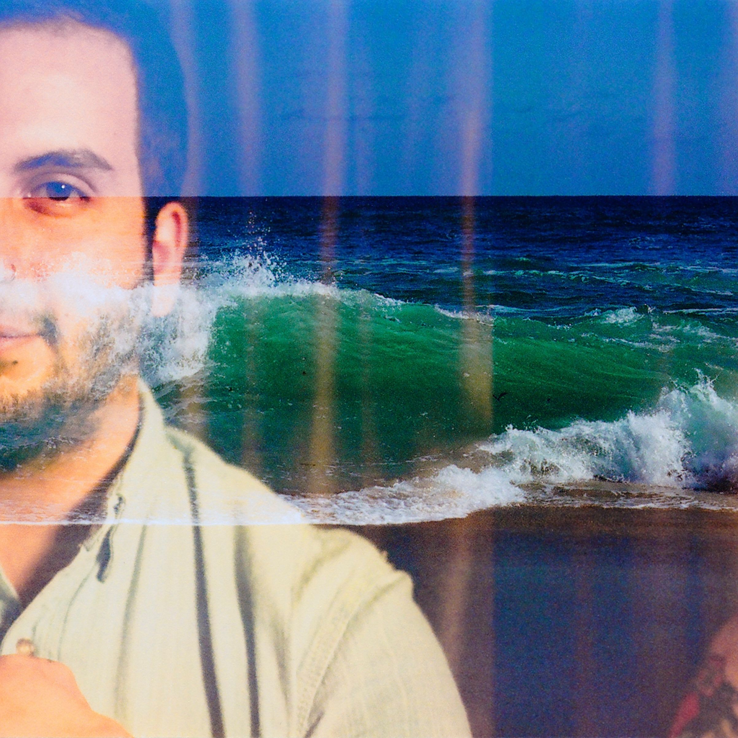 man with waves crashing
