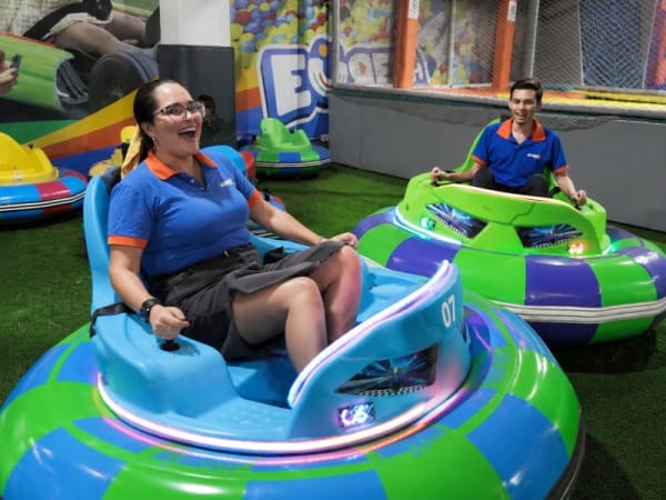 Adults enjoying heavy-duty commercial trackless bumper cars with LED lighting. These PE rotomolded rides are engineered for maximum durability in indoor FEC and outdoor amusement park environments.