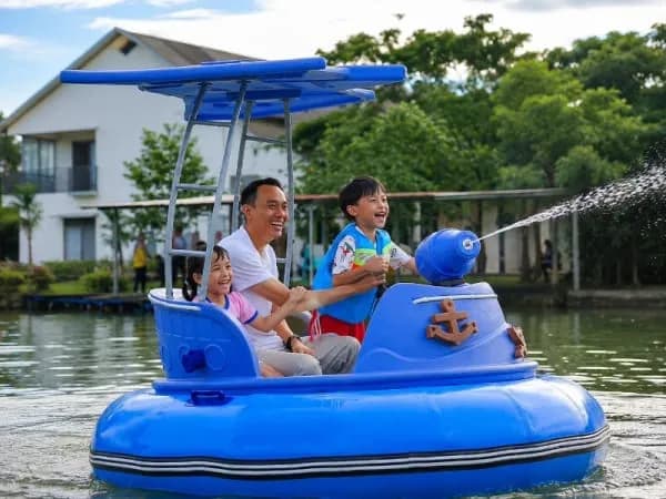 Father and children riding a seamless PE bumper boat at Dinesti Land, verifying QIQU's equipment integration and family appeal.