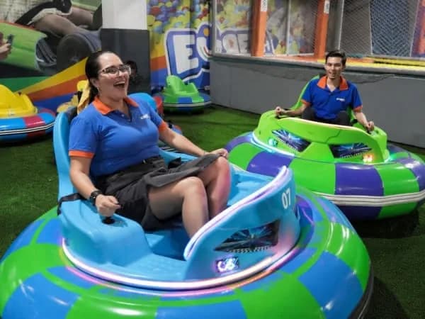 Commercial trackless bumper cars in operation at an indoor family entertainment venue.