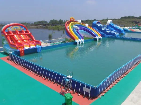Large custom inflatable water park installed on a lake for a commercial amusement attraction.