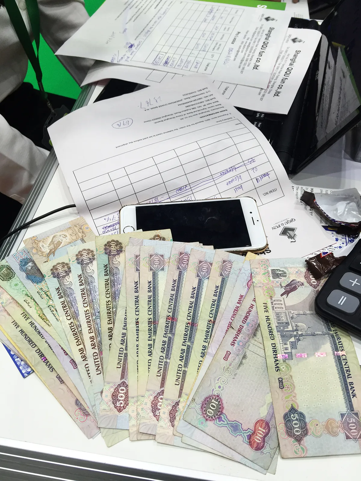 On-site AED cash deposits and signed proforma invoices for commercial bumper cars collected at Shanghai Qiqu Fun booth during IAAPA Dubai