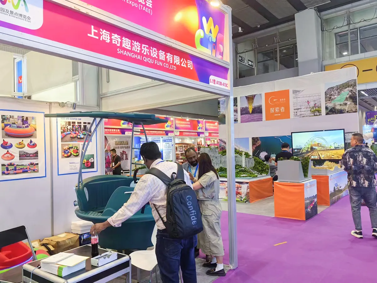 Global park operators physically inspecting the heavy-duty HDPE hull of our flagship Pirate Bumper Boat with Founder Emily at Canton Fair 2024