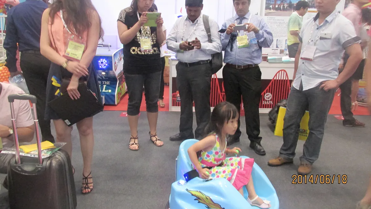 International amusement park buyers capturing the high-engagement appeal of our commercial bumper cars in action at CAAPA Expo Beijing 2014