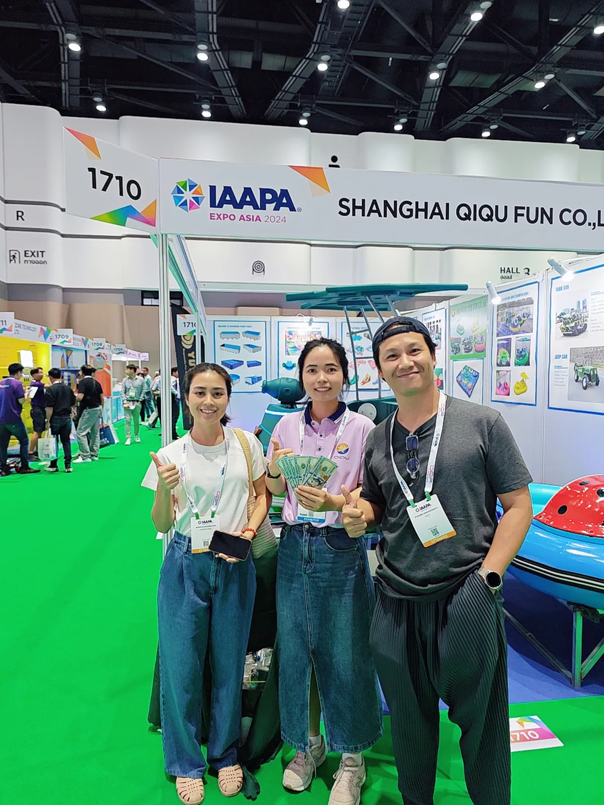 International park operators paying USD cash deposit for commercial kids bumper boats at Shanghai Qiqu Fun booth during IAAPA Expo Asia 2024 Bangkok