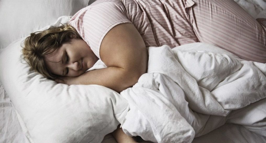 Plus Sized woman sleeping on bed