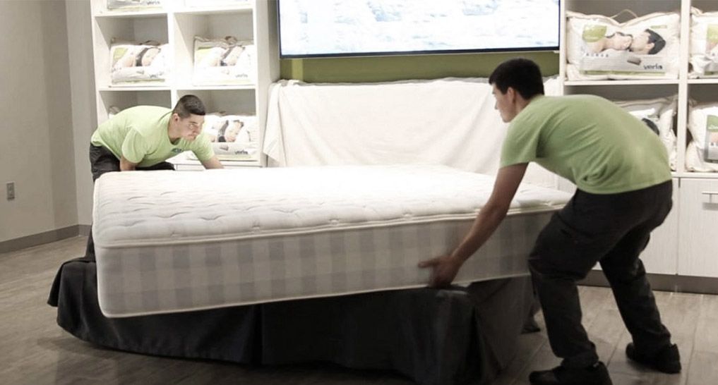 Men flipping a mattress