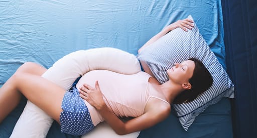 A pregnant lady sleeping on right side which might be risky for the fetus