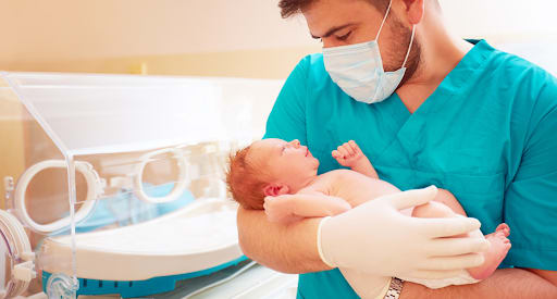 A doctor holding a baby at Erica Shane Childbirth 
