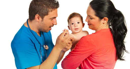 A doctor playing with a baby. Mommywise provides volunteer service to assist new families.
