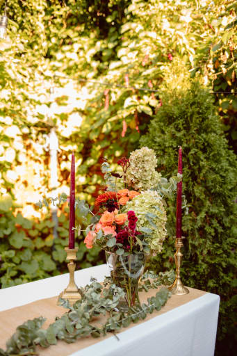 Candlesticks and floral arrangements on table settings.