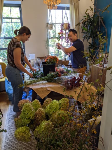 Claire and Jeremy preparing arrangements after a trip to the flower market.