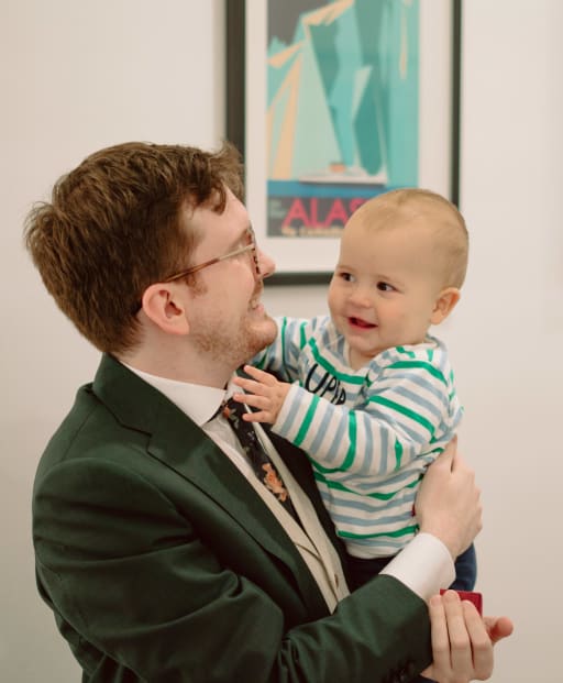 Hans holding a baby.