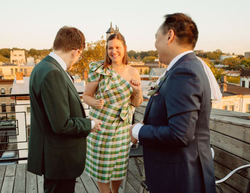 Claire laughs with the grooms.