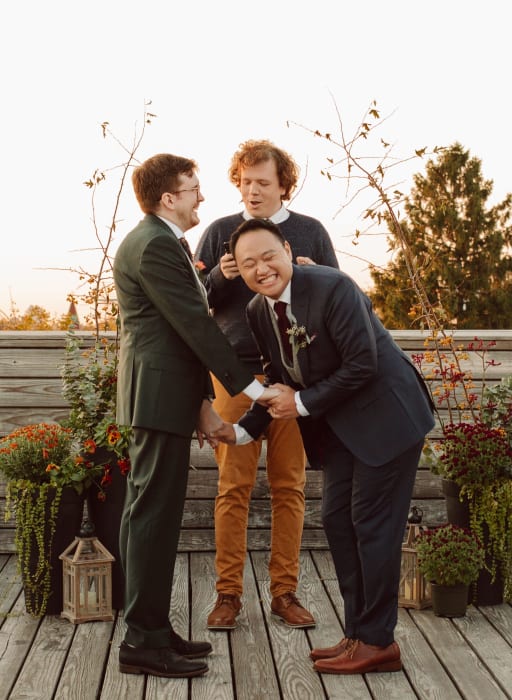 Jeremy laughs while holding hands with Hans at the front.