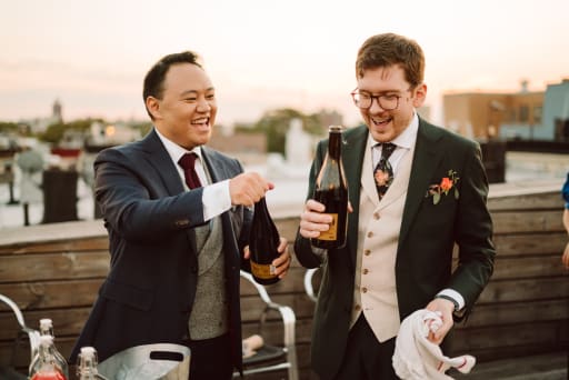 Hans and Jeremy holding Lambrusco bottles.