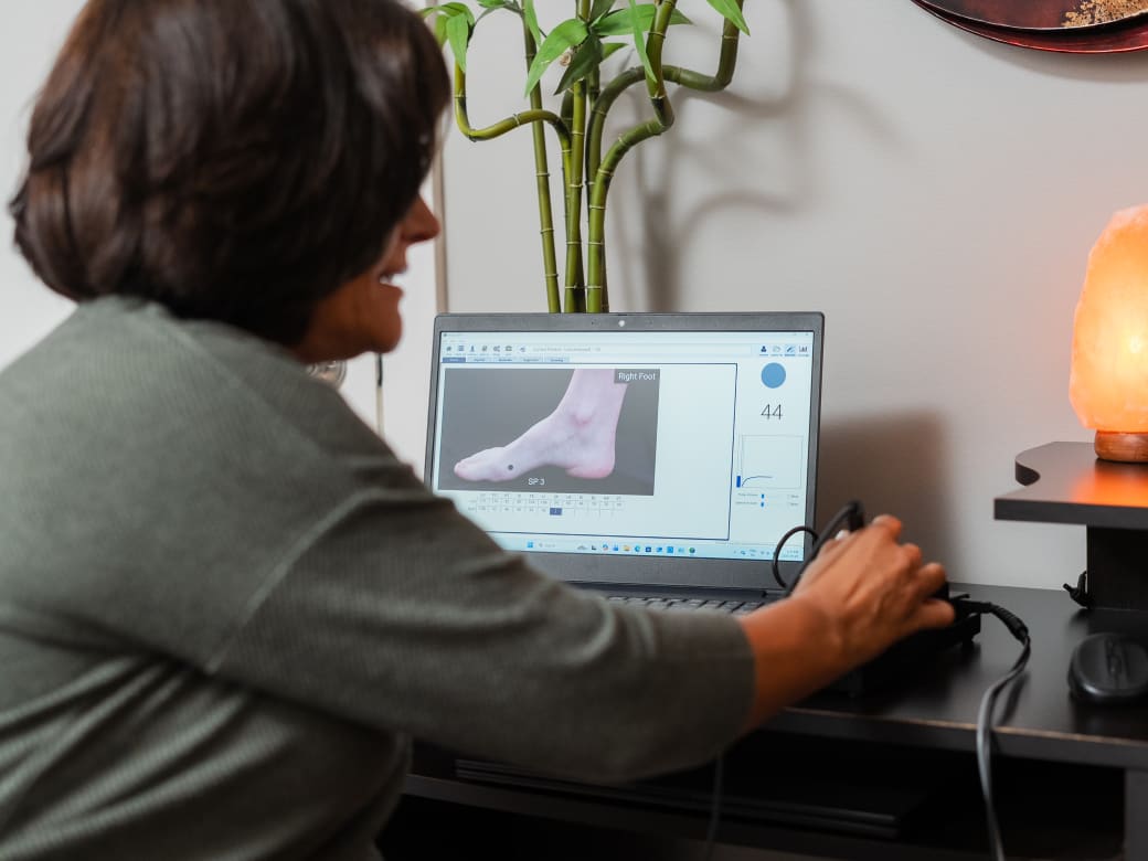 Nadine Cormier reviewing an AcuGraph assessment on screen with a patient