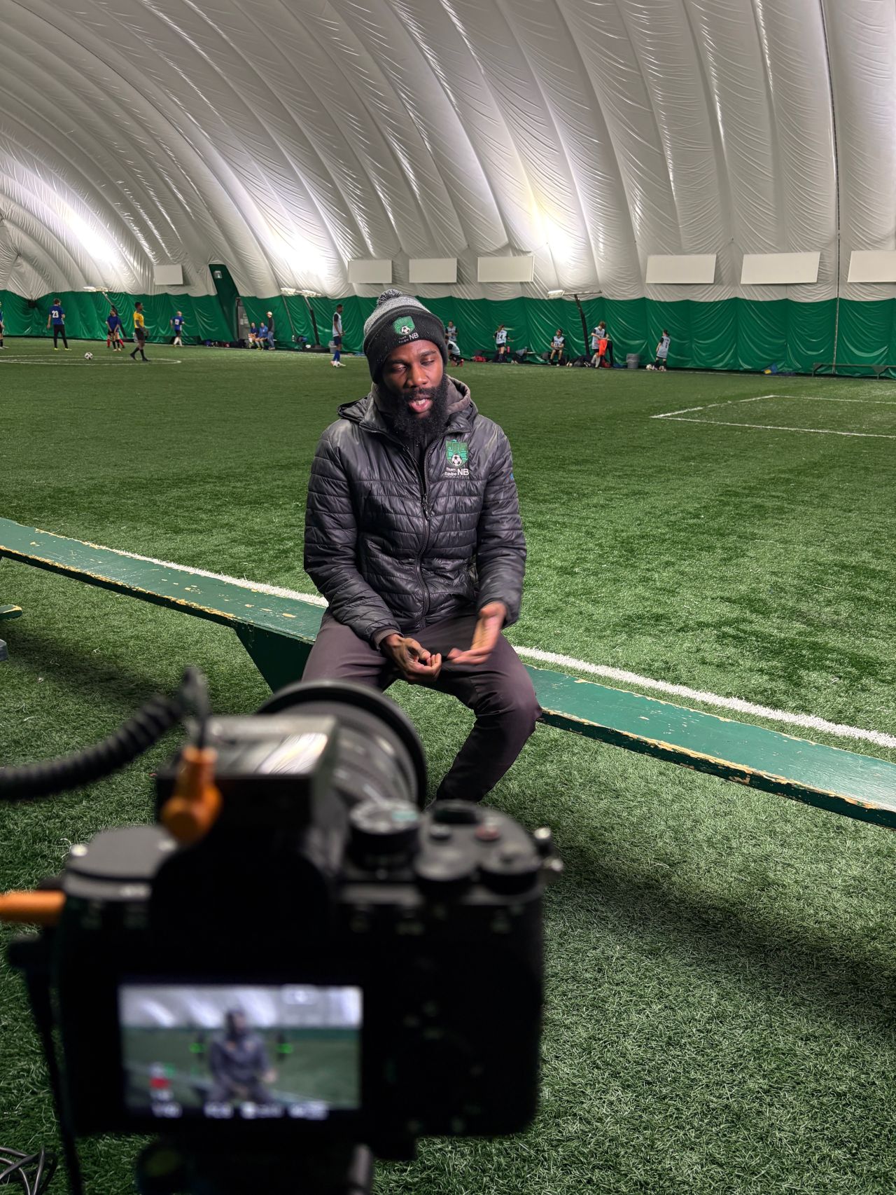 Heritier Masimengo and Soccer NB players during filming in Moncton, New Brunswick for the United Nations' More Than a Game World Cup campaign