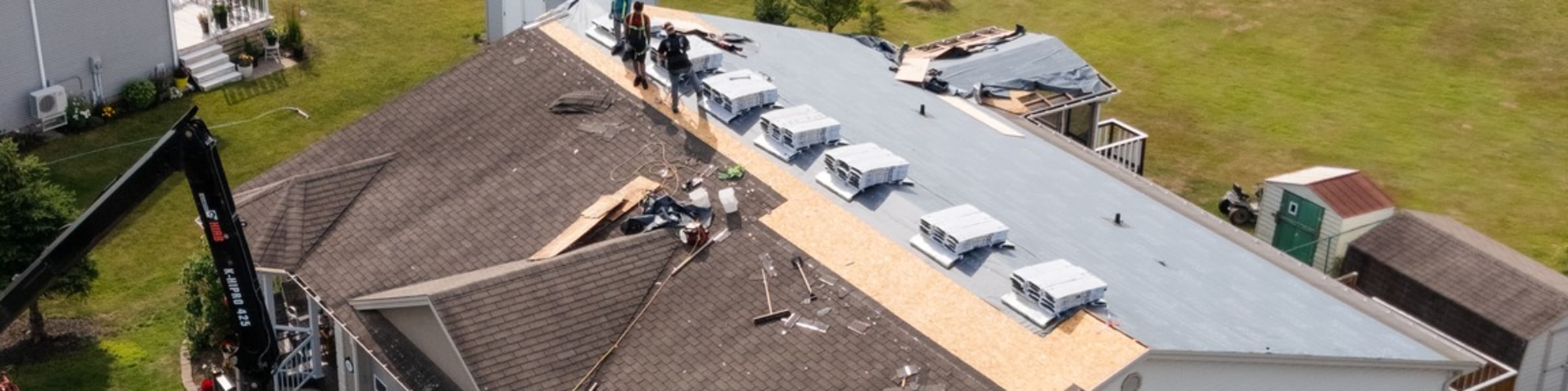 J.A. Kelly roofing crew working on a roof replacement in Moncton NB