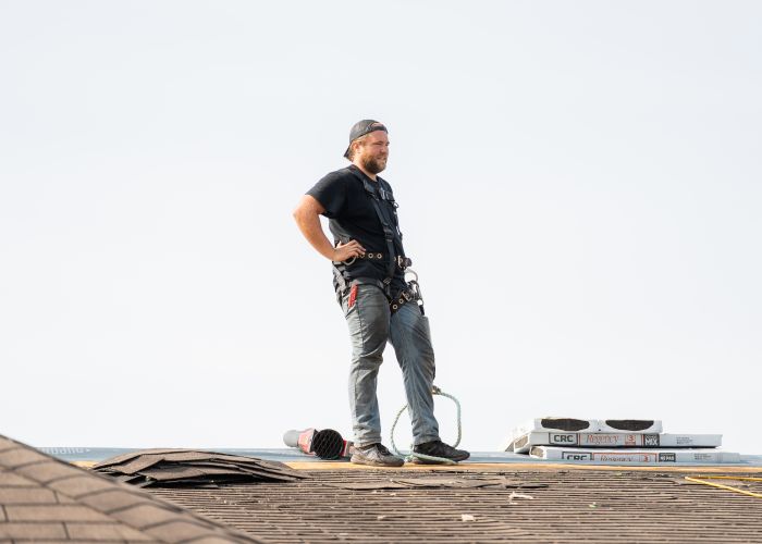 J.A. Kelly roofer inspecting roof in Riverview