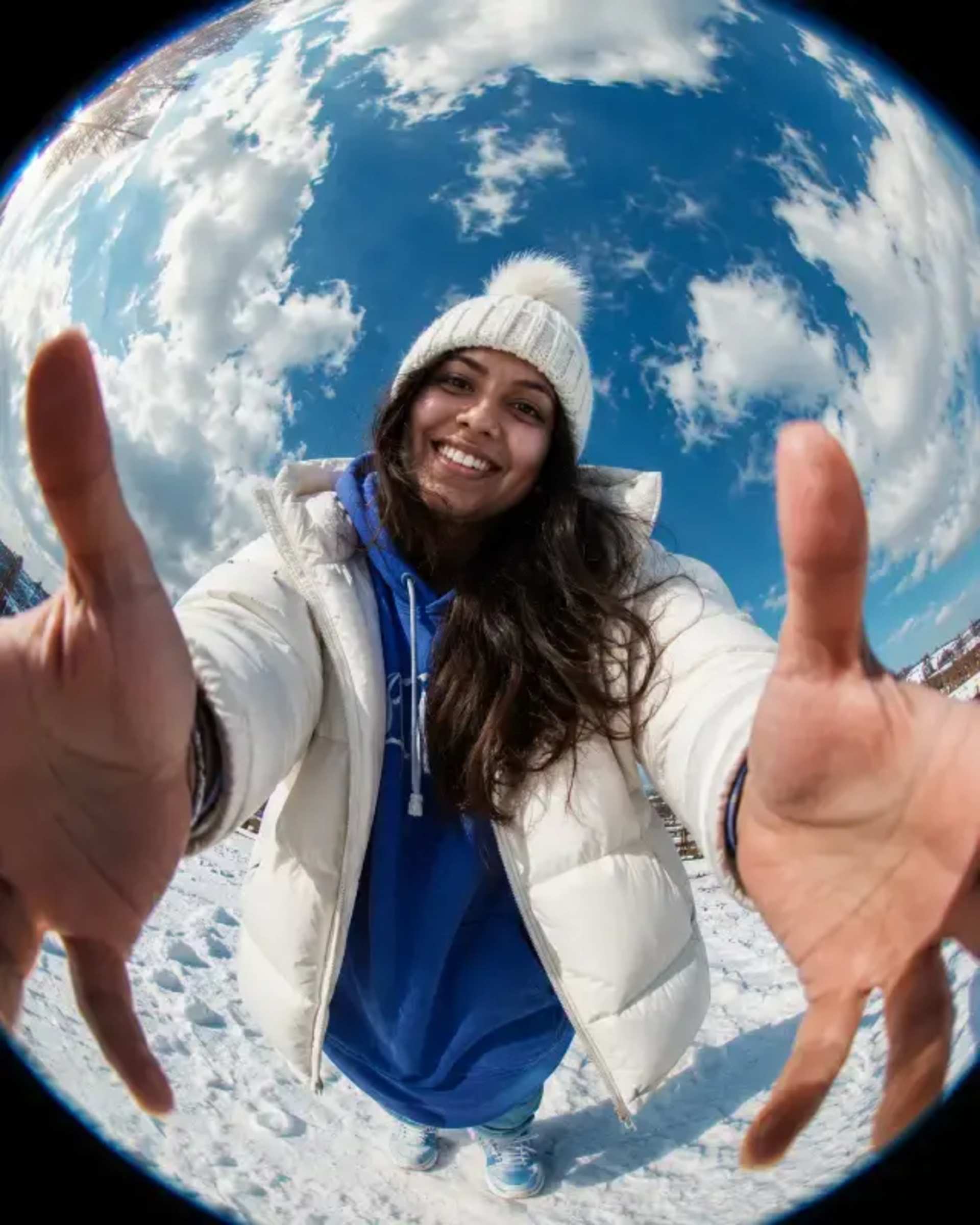 Fisheye Streetwear Snowy Portrait prompt - streetwear portrait, extreme fisheye lens, exaggerated perspective, oversized hands, snowy landscape, vibrant blue sky, cinematic clouds, white puffer jacket, blue hoodie, winter fashion, youthful aesthetic, editorial photography, hyperrealistic detail, 4:5 portrait composition