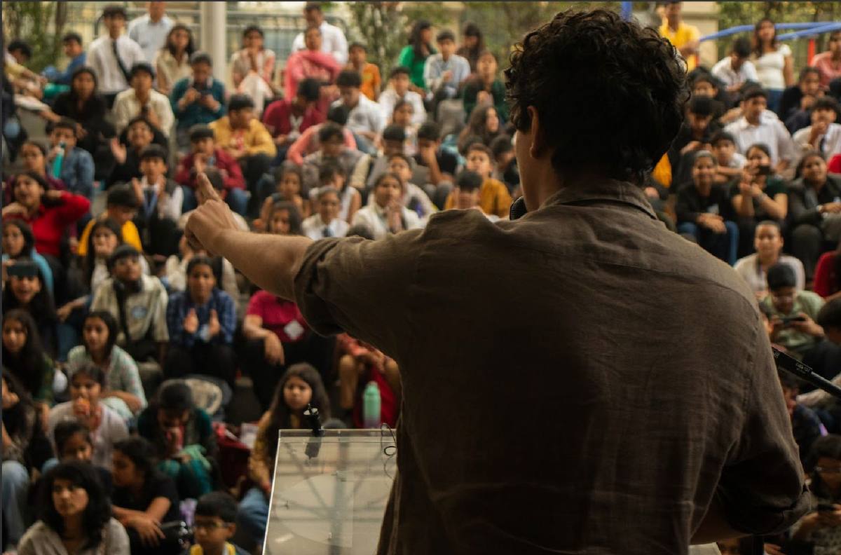 Students presenting to a large audience