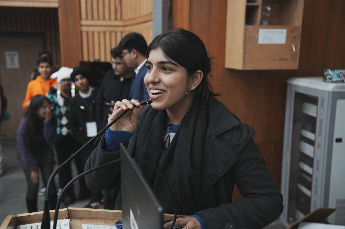 Student speaking confidently at microphone