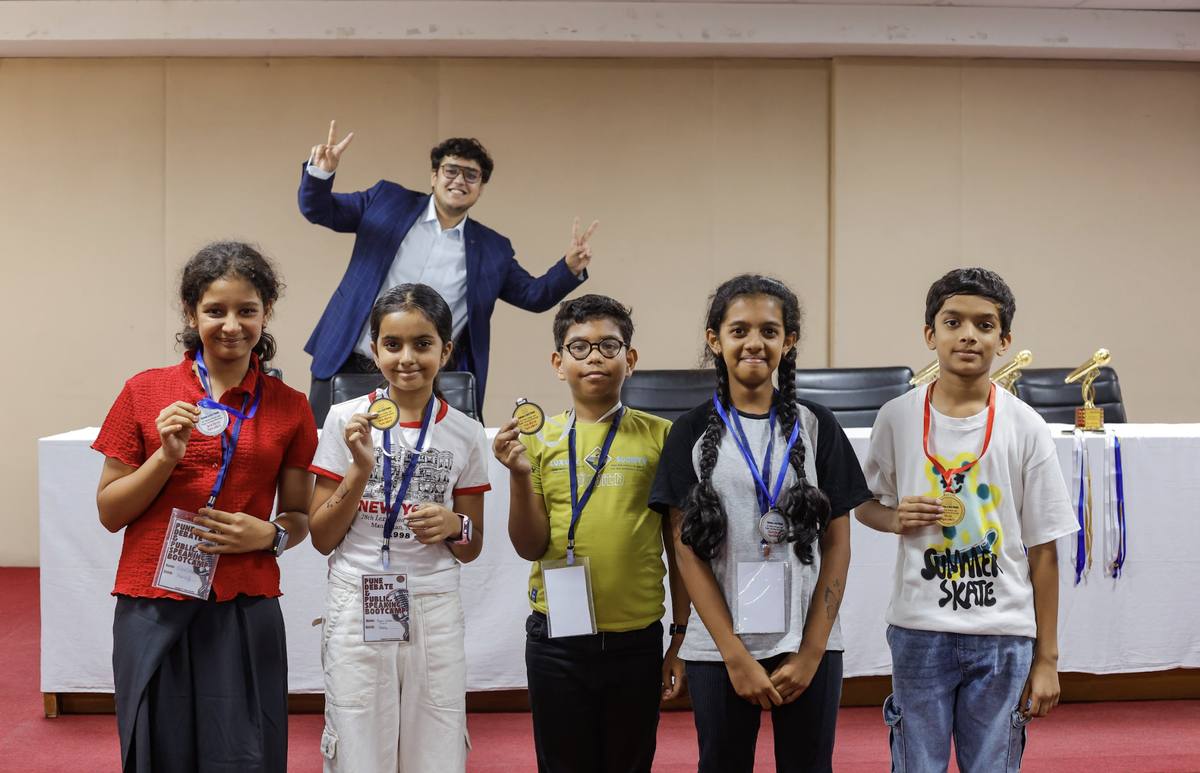 Young students proudly wearing medals