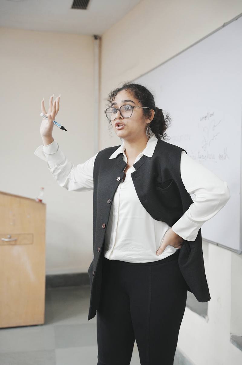 Trainer guiding students through debate techniques