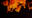 Abstract image of orange, swirling, smoke-like forms set against a black background. The forms evoke a sense of movement and energy. blurred out low res