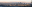 This is a panoramic photograph of a city skyline at sunset, with mountains and clouds in the background, and a beach in the foreground. blurred out low res