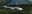 A striking photograph capturing two birds mid-flight. The image emphasizes the birds' dynamic pose and the contrast between light and shadow. blurred out low res