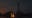 A pixelated landscape features a dark tower and flowing lava against a starry night sky. The scene has a digital art style, reminiscent of a video game environment. blurred out low res