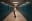A woman poses in a school hallway, leaning back dramatically. The scene is framed by rows of teal lockers, leading the eye into the distance. blurred out low res
