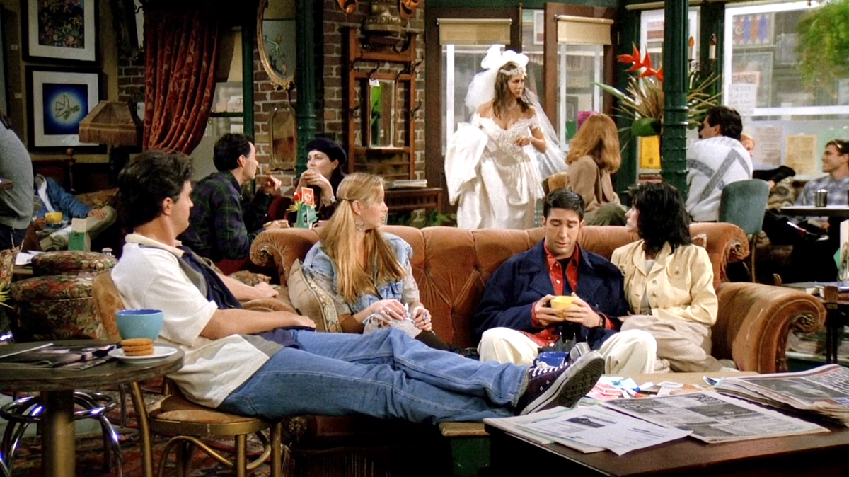 Close-up of Rachel's runaway bride look—lace wedding dress, tulle veil, and pearl choker