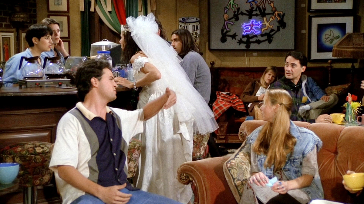 Close-up of Rachel's runaway bride look—lace wedding dress, tulle veil, and pearl choker