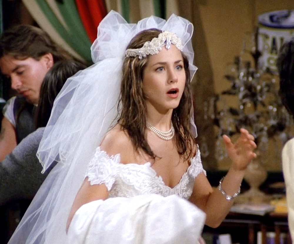 Close-up of Rachel's runaway bride look—lace wedding dress, tulle veil, and pearl choker