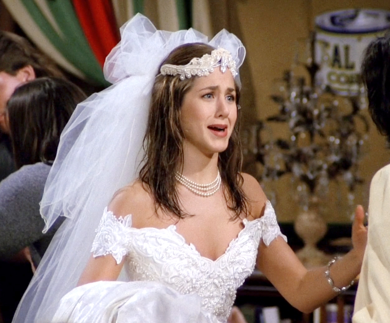 Close-up of Rachel's runaway bride look—lace wedding dress, tulle veil, and pearl choker