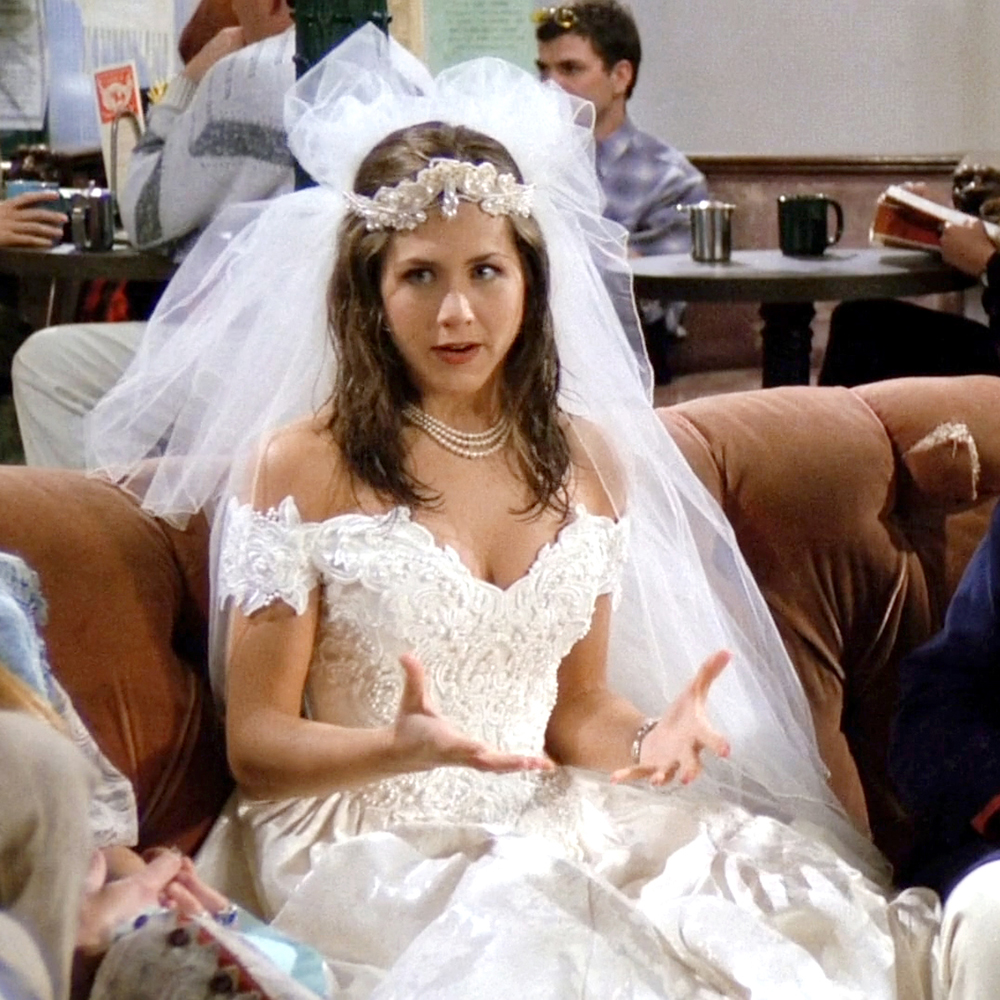 Close-up of Rachel's runaway bride look—lace wedding dress, tulle veil, and pearl choker